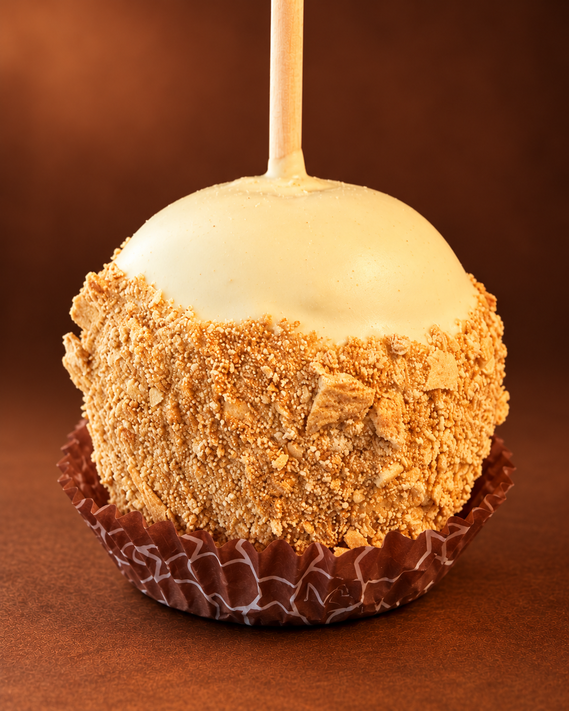 Pumpkin Cheesecake Caramel Apple with golden crumb coating