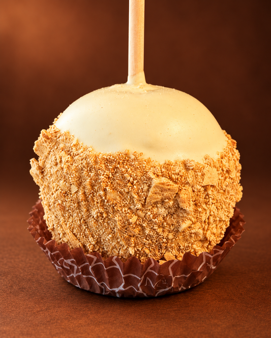 Pumpkin Cheesecake Caramel Apple with golden crumb coating